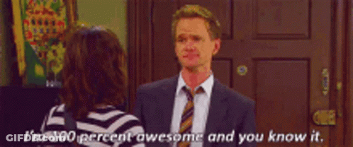 A Man In A Suit And Tie Is Talking To A Woman Who Is Wearing A Striped Shirt GIF