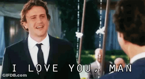 A Man In A Suit And Tie Is Talking To Another Man And Says I Love You Man . GIF