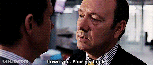A Man In A Suit And Tie Is Talking To Another Man And Says I Own You Your My Bitch . GIF