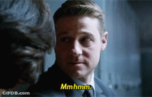 A Man In A Suit And Tie Is Talking To Another Man And Says Mmhmm GIF