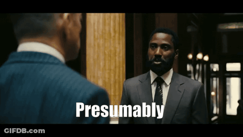 A Man In A Suit And Tie Is Talking To Another Man And The Words Presumably Are Visible GIF