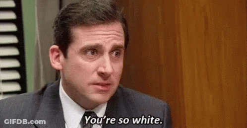 A Man In A Suit And Tie Is Talking To Another Man In A Room . GIF