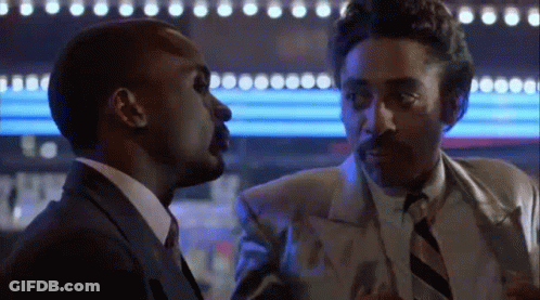 A Man In A Suit And Tie Is Talking To Another Man In A Suit And Tie . GIF