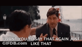 A Man In A Suit And Tie Is Talking To Another Man In A Suit And Tie . GIF