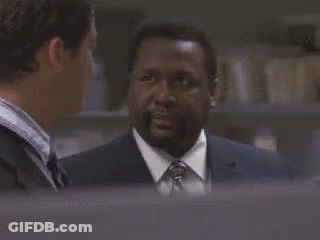 A Man In A Suit And Tie Is Talking To Another Man In A Suit And Tie . GIF