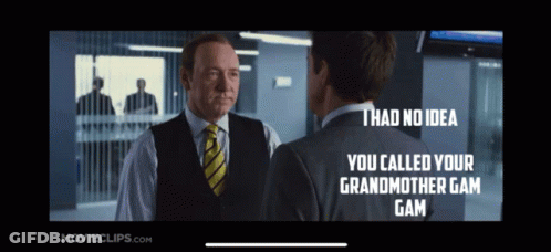 A Man In A Suit And Tie Is Talking To Another Man In A Suit And Vest GIF