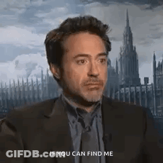 A Man In A Suit And Tie Is Talking To Another Man . GIF