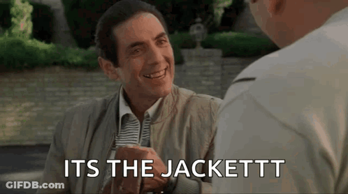 A Man In A Suit And Tie Is Talking To Another Man While Holding A Glass Of Beer . GIF