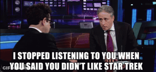 A Man In A Suit And Tie Is Talking To Another Man Who Says " I Stopped Listening To You " GIF