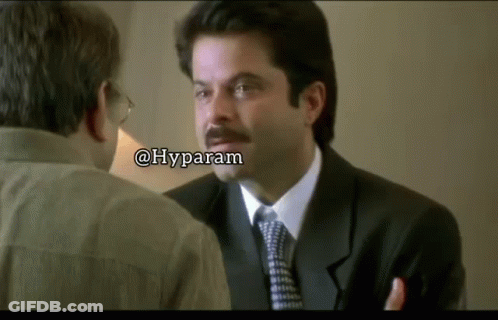A Man In A Suit And Tie Is Talking To Another Man With A Caption That Says Hyparam GIF