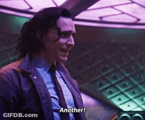 A Man In A Suit And Tie Is Talking To Another Person . GIF