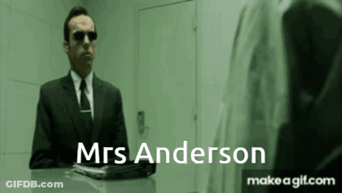 A Man In A Suit And Tie Is Talking To Mrs Anderson . GIF