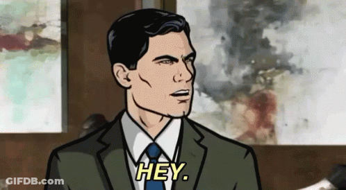 A Man In A Suit And Tie Is Talking To Someone And Saying Hey . GIF