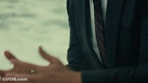 A Man In A Suit And Tie Is Talking To Someone . GIF