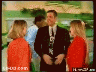 A Man In A Suit And Tie Is Talking To Two Girls GIF