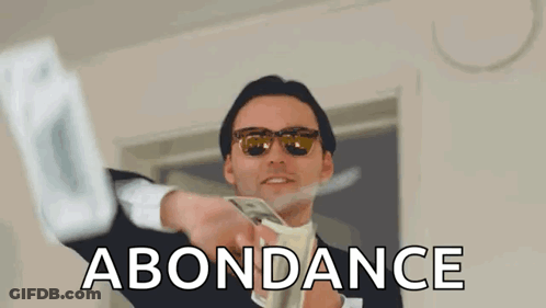 A Man In A Suit And Tie Is Throwing Money In The Air And The Word Abundance Is Above Him GIF