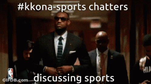 A Man In A Suit And Tie Is Walking Down A Hallway With A Caption That Says #Kkona-Sports Chatters GIF