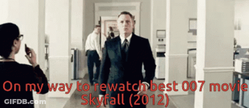 A Man In A Suit And Tie Is Walking Down A Hallway With The Words On My Way To Rewatch Best 007 Movie Skyfall 2012 GIF