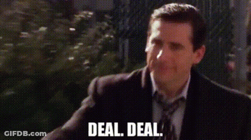 A Man In A Suit And Tie Is Walking Down A Street And Says `` Deal , Deal '' . GIF