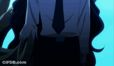 A Man In A Suit And Tie Is Walking In The Dark GIF