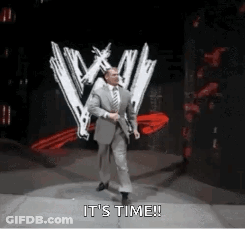 A Man In A Suit And Tie Is Walking On A Stage With The Words `` It 'S Time '' . GIF