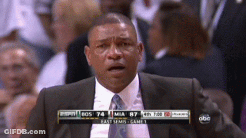 A Man In A Suit And Tie Is Watching A Game On Espn GIF