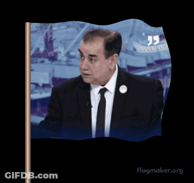 A Man In A Suit And Tie Is Waving A Flag That Says Flagmaker.org On It GIF