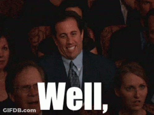 A Man In A Suit And Tie Is Waving In Front Of A Crowd With The Words Well Written In White GIF