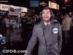 A Man In A Suit And Tie Is Wearing A Badge That Says Abc GIF