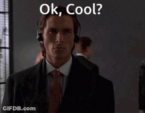 A Man In A Suit And Tie Is Wearing A Headset And Says Ok Cool GIF