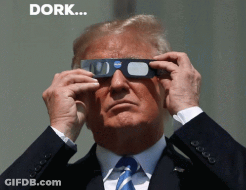 A Man In A Suit And Tie Is Wearing A Pair Of Nasa Glasses GIF