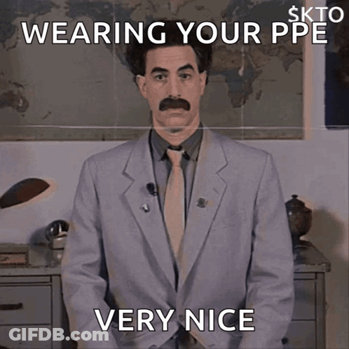 A Man In A Suit And Tie Is Wearing A Ppe And Is Very Nice GIF