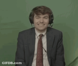 A Man In A Suit And Tie Is Wearing Headphones And A Headset . GIF