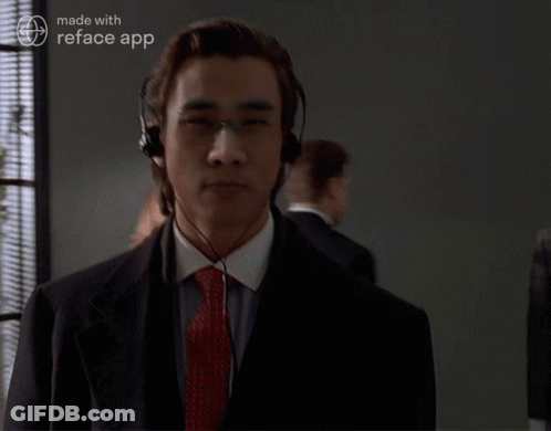 A Man In A Suit And Tie Is Wearing Headphones And A Reface App Logo GIF
