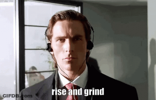 A Man In A Suit And Tie Is Wearing Headphones And The Words Rise And Grind Are On His Face . GIF
