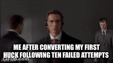 A Man In A Suit And Tie Is Wearing Headphones While Standing In Front Of A Group Of People . GIF