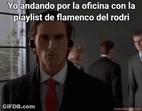 A Man In A Suit And Tie Is Wearing Headphones With The Caption Yo Andando Por La Oficina GIF