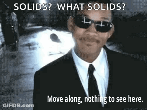 A Man In A Suit And Tie Is Wearing Sunglasses And A Caption That Says Solids What Solids Move Along Nothing To See Here GIF