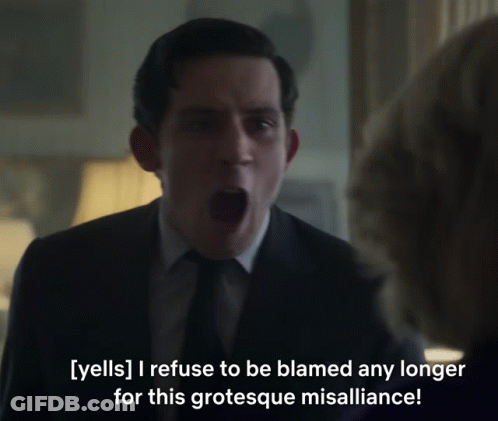 A Man In A Suit And Tie Is Yelling At A Woman GIF