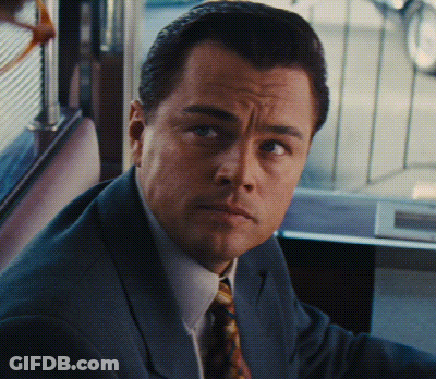 A Man In A Suit And Tie Looks At The Camera With A Serious Look On His Face GIF