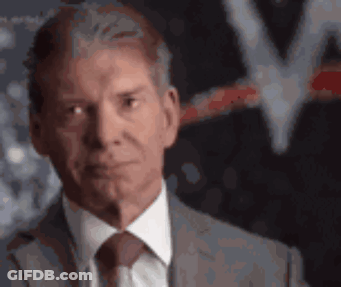 A Man In A Suit And Tie Looks Serious GIF