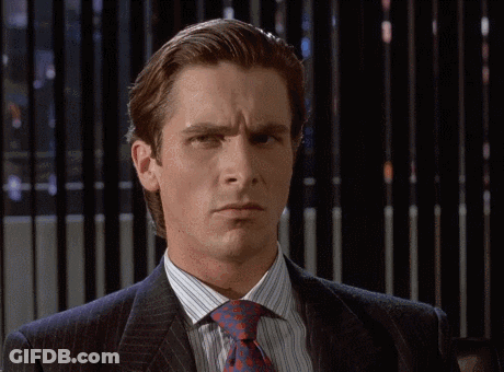 A Man In A Suit And Tie Looks Serious GIF