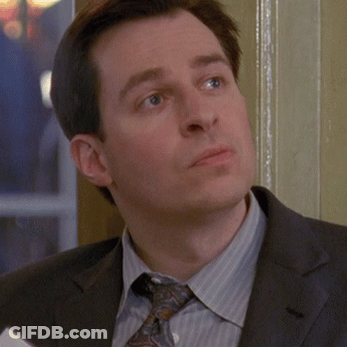 A Man In A Suit And Tie Looks Serious GIF