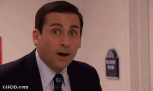 A Man In A Suit And Tie Looks Surprised In Front Of A Sign That Says Blind Room GIF