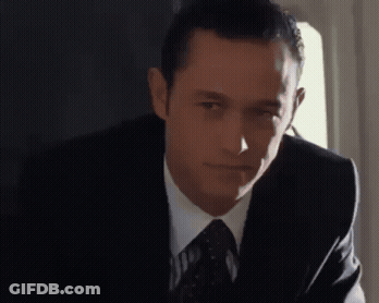 A Man In A Suit And Tie Looks To The Side GIF