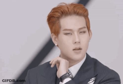 A Man In A Suit And Tie Makes A Heart Shape With His Hands GIF