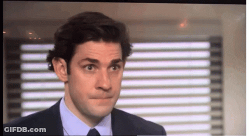 A Man In A Suit And Tie Making A Face GIF