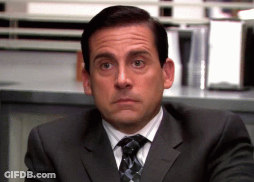 A Man In A Suit And Tie Making A Face GIF