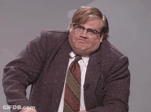 A Man In A Suit And Tie Making A Face GIF