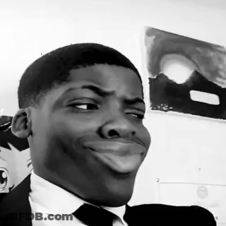A Man In A Suit And Tie Making A Funny Face GIF